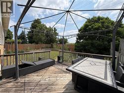 Expansive wooden deck featuring a gazebo frame - 