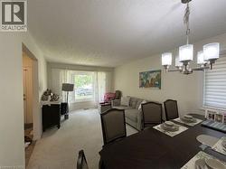 Open concept living and dining area featuring a prominent bay window - 
