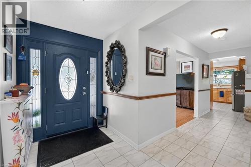 Entry foyer featuring a tiled floor, a paneled front door with decorative glass, and sidelight windows - 3 Orchard Parkway, Grimsby, ON - Indoor