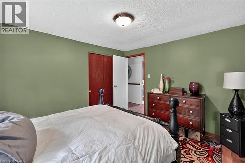 Warm room featuring a wood-finish floor, a closet with bi-fold doors, and a ceiling light fixture - 3 Orchard Parkway, Grimsby, ON - Indoor Photo Showing Bedroom