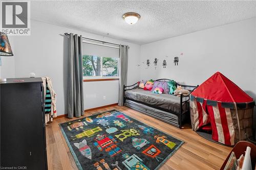 Bright room featuring wood-finish flooring and a single window with curtain rods - 3 Orchard Parkway, Grimsby, ON - Indoor