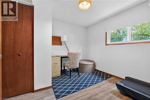 Interior space featuring wood-finish flooring, white painted walls, and a window with wood trim - 3 Orchard Parkway, Grimsby, ON - Indoor Photo Showing Other Room
