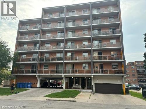 Multi-story brick facade building featuring individual balconies with glass railings - 30 Summit Avenue Unit# 604, Hamilton, ON - Outdoor With Balcony With Facade