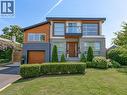 Modern architectural design featuring varied facade materials including wood-finish siding, stone, and dark brick - 5178 Hunter Drive, Burlington, ON 