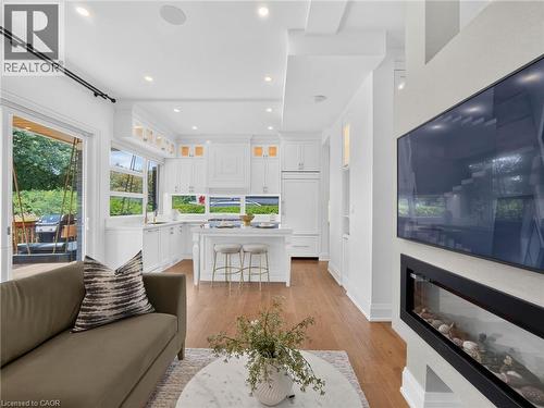 Open-concept living space featuring hardwood flooring and recessed lighting - 5178 Hunter Drive, Burlington, ON - Indoor Photo Showing Living Room With Fireplace