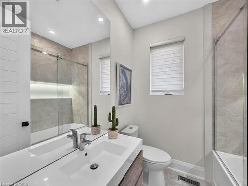 Bathroom featuring a vanity with an integrated sink, chrome fixtures, and a large mirror - 5178 Hunter Drive, Burlington, ON - Indoor Photo Showing Bathroom