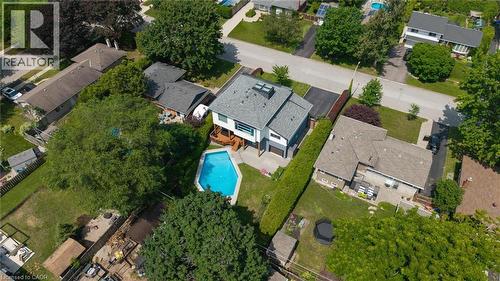 In-ground swimming pool with surrounding patio space - 5178 Hunter Drive, Burlington, ON - Outdoor With View