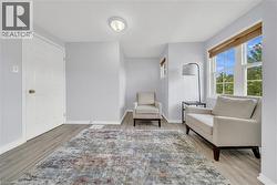 Room featuring light wood-finish flooring, white baseboards, and light gray walls - 