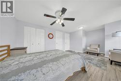 Spacious interior with neutral wall tones and wood-finish flooring - 