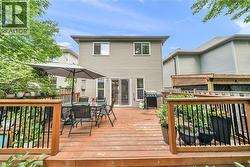 Expansive wooden deck with dark metal railings - 