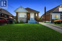 Brick exterior featuring a gabled roofline, bay window, and covered entry - 