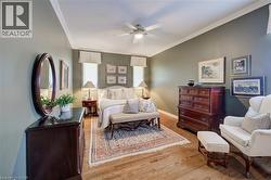 Hardwood flooring extends throughout this room, featuring vaulted ceilings and crown molding - 