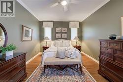 Bedroom featuring wood-finish flooring, crown molding, professionally designed - 