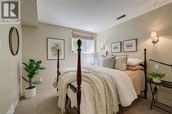 Carpeted bedroom featuring neutral wall tones, large window - 