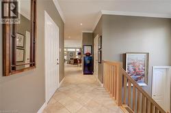 Entryway featuring neutral wall tones, crown molding, recessed lighting, and tile flooring - 