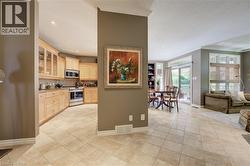 Open-concept layout featuring light-toned porcelain flooring throughout - 