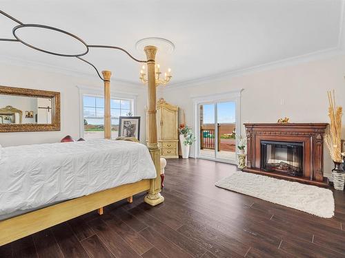 29 Laughlin Street, Miscouche, PE - Indoor Photo Showing Bedroom With Fireplace