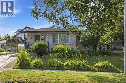 Light-colored brick exterior featuring a dark asphalt shingle roof - 11 Summit Crescent, Guelph, ON - Outdoor