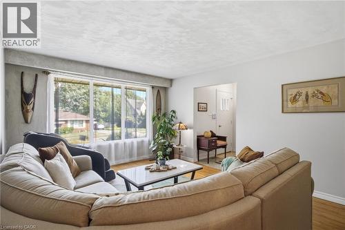 Living area with wood-finish flooring and a large picture window - 11 Summit Crescent, Guelph, ON - Indoor Photo Showing Living Room