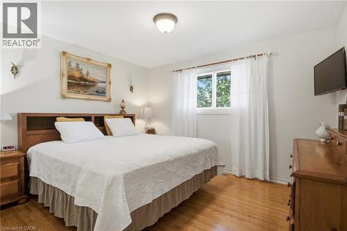 Bedroom featuring wood-finish flooring, a double window with white curtains, white walls, and a ceiling-mounted light fixture - 11 Summit Crescent, Guelph, ON - Indoor Photo Showing Bedroom