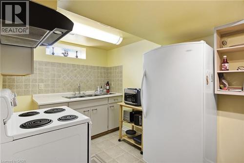 Compact kitchen featuring a white electric range, white refrigerator, and light-colored cabinetry - 11 Summit Crescent, Guelph, ON - Indoor Photo Showing Kitchen With Double Sink