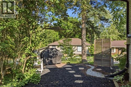 Landscaped outdoor area featuring dark ground cover, stepping stones, and a decorative gravel path - 11 Summit Crescent, Guelph, ON - Outdoor