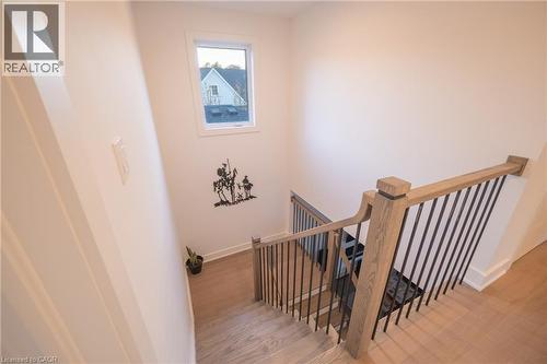 Staircase featuring wood-finish treads and risers, a light wood-finish handrail, and black metal balusters - 9 Princeton Common, St. Catharines, ON - Indoor Photo Showing Other Room