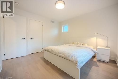 Light wood-finish flooring complements clean white walls - 9 Princeton Common, St. Catharines, ON - Indoor Photo Showing Bedroom