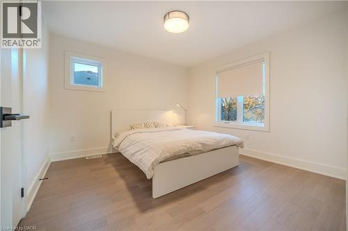 Light wood-finish flooring provides a neutral foundation, complemented by white walls and trim - 9 Princeton Common, St. Catharines, ON - Indoor Photo Showing Bedroom