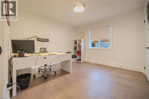 Bright room featuring light wood-finish flooring, white walls, and a modern ceiling light fixture - 9 Princeton Common, St. Catharines, ON - Indoor Photo Showing Office
