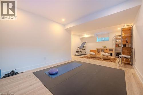 Recessed lighting illuminating a spacious room with light wood-finish flooring - 9 Princeton Common, St. Catharines, ON - Indoor Photo Showing Other Room