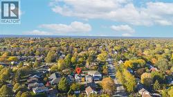 Aerial perspective showcasing residential properties amidst extensive tree coverage - 