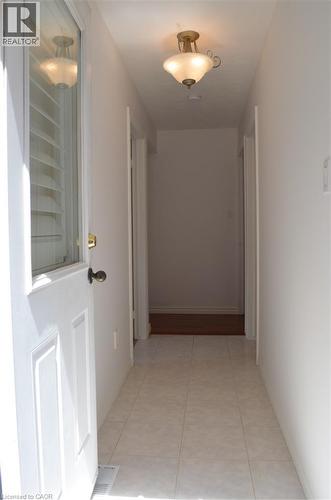 Entryway featuring white panel door with glass insert, overhead semi-flush mount light fixture, and ceramic tile flooring - 275 Locheed Drive Unit# Lower, Hamilton, ON - Indoor Photo Showing Other Room