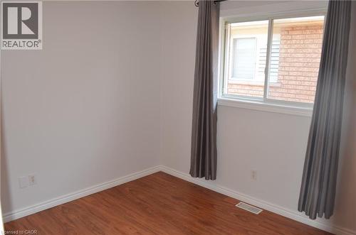 Room featuring light-colored walls, wood-finish flooring, and white baseboards - 275 Locheed Drive Unit# Lower, Hamilton, ON - Indoor Photo Showing Other Room