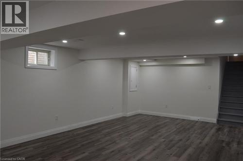 Finished lower-level space featuring recessed lighting, wood-finish flooring, white baseboards, and a window with a white frame - 275 Locheed Drive Unit# Lower, Hamilton, ON - Indoor