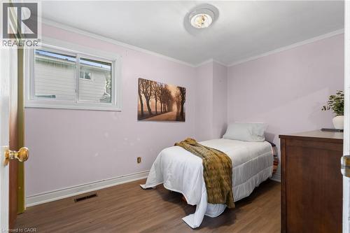Room featuring wood-finish flooring, a window with white trim, and a ceiling-mounted light fixture - 383 Bartley Bull Parkway, Brampton, ON - Indoor Photo Showing Bedroom