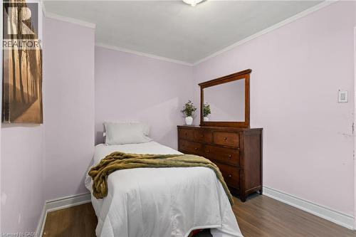 Room featuring wood-finish flooring, white baseboards, and white crown molding - 383 Bartley Bull Parkway, Brampton, ON - Indoor Photo Showing Bedroom
