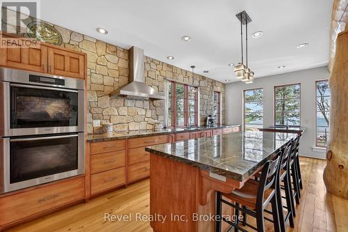 Miele double oven and beautiful Stone wall - 12 Walker Road, Tiny, ON - Indoor Photo Showing Kitchen With Upgraded Kitchen