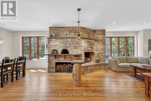Rumford Fireplace & adjacent pizza oven - 12 Walker Road, Tiny, ON - Indoor Photo Showing Living Room With Fireplace