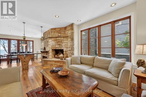 reclaimed elm floors and potlights ( led & halogen - 12 Walker Road, Tiny, ON - Indoor Photo Showing Living Room With Fireplace