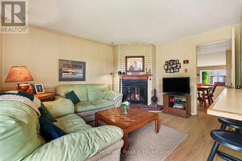 Family room with wood fireplace - 41 Aldgate Crescent, Ottawa, ON - Indoor Photo Showing Living Room With Fireplace