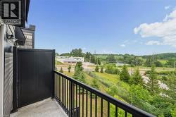 Outdoor balcony featuring a black metal railing and privacy partition - 
