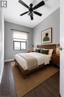 Bedroom featuring dark wood-finish flooring, a contemporary window with a roller shade, and a black ceiling fan with integrated lighting - 
