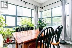 Room featuring extensive window walls with dark framing, providing abundant natural light - 