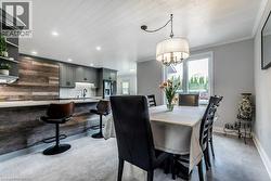 Open-concept living space with shiplap ceiling, recessed lighting, and light-toned flooring - 