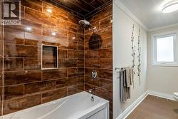 Bathtub and shower combination featuring dark wood-look tile surround with an integrated shower niche - 