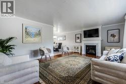 Formal living area featuring a white mantel fireplace with marble surround - 