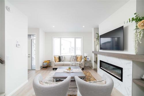 109 Ken Oblik Drive, Winnipeg, MB - Indoor Photo Showing Living Room With Fireplace