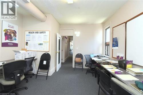 Carpeted interior space featuring light-colored walls and a drop ceiling - 108 George Street, Hamilton, ON 