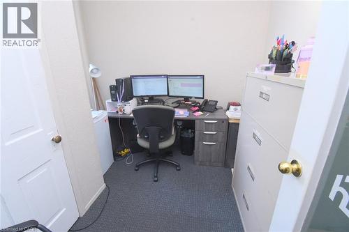 Dedicated room featuring textured wall finishes and dark gray carpet flooring - 108 George Street, Hamilton, ON 